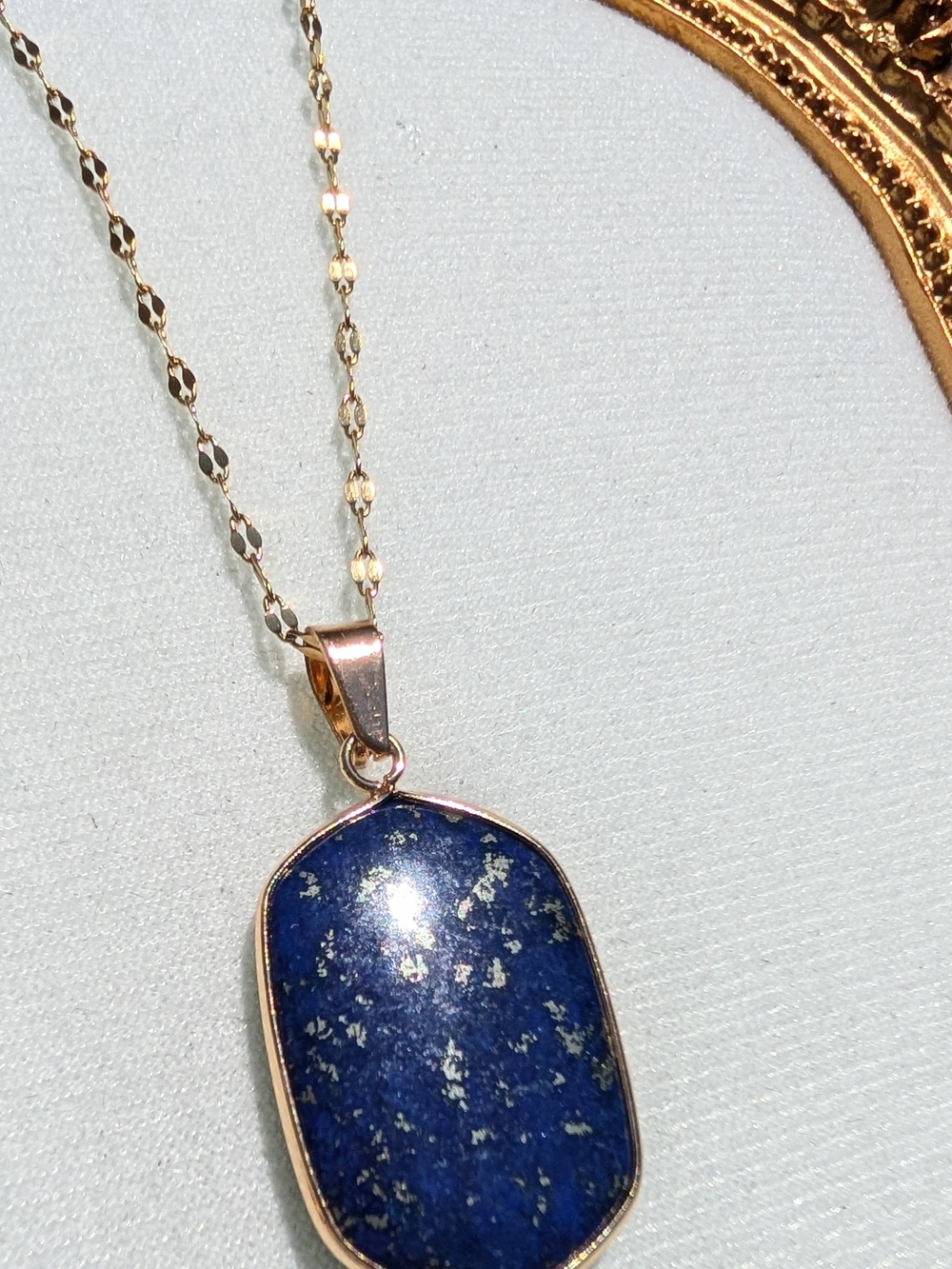 Deep blue Lapis Lazuli pendant with gold flecks. Gold-tone bezel